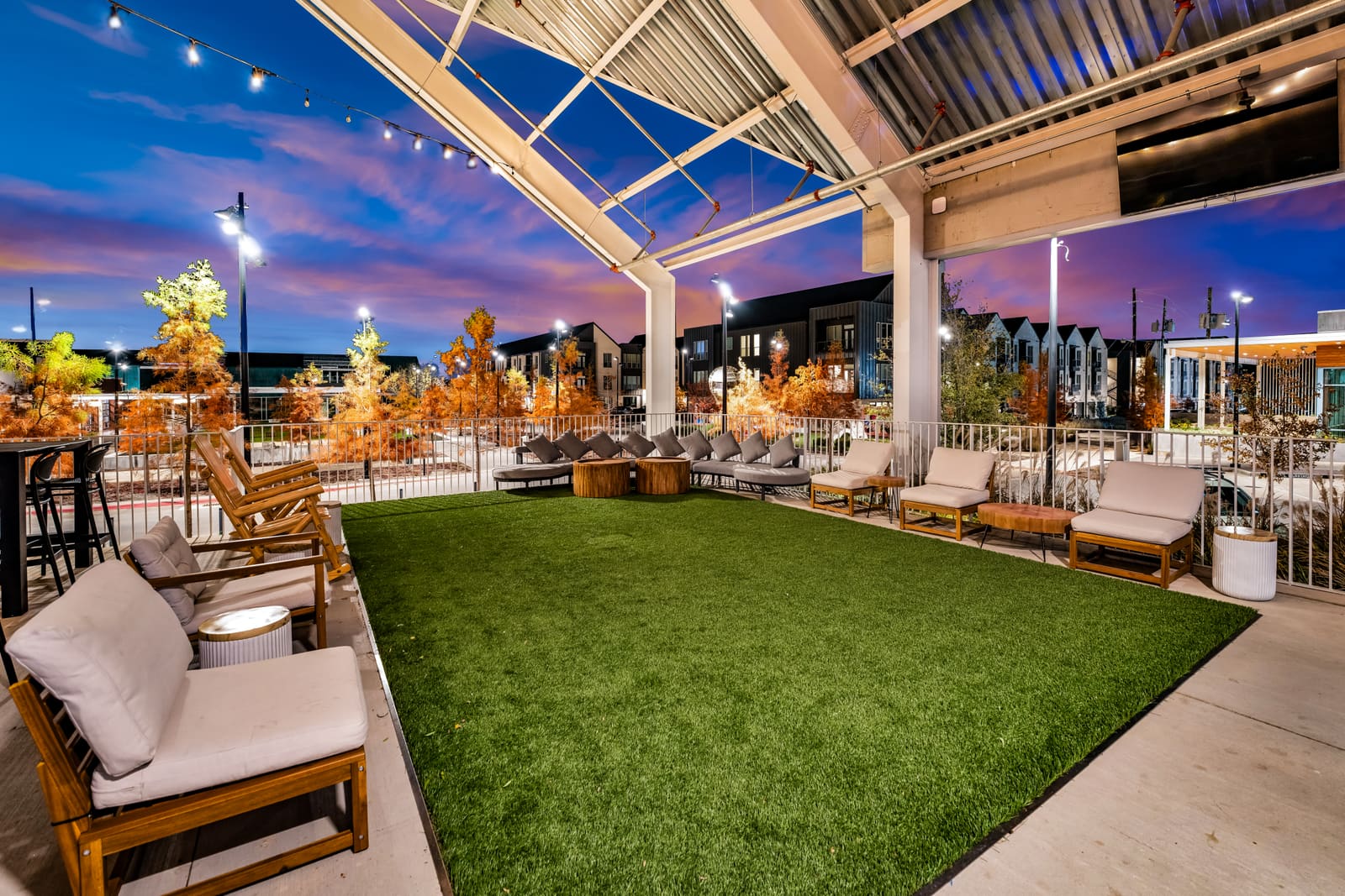 The patio at Assembly Icehouse — turf, picnic tables and open air